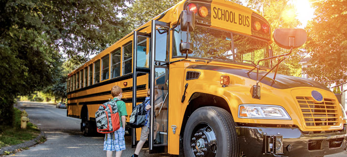 students getting onto school bus